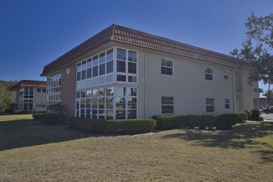 Desirable corner 'B' unit with split bedrooms and sweeping lake on The American Golf Club in Florida - for sale on GolfHomes.com, golf home, golf lot
