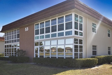 Desirable corner 'B' unit with split bedrooms and sweeping lake on The American Golf Club in Florida - for sale on GolfHomes.com, golf home, golf lot