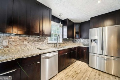 Welcome to this beautiful brick front home nestled on a sweeping on Hidden Hills Country Club in Georgia - for sale on GolfHomes.com, golf home, golf lot