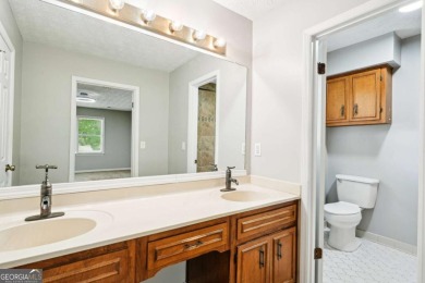 Welcome to this beautiful brick front home nestled on a sweeping on Hidden Hills Country Club in Georgia - for sale on GolfHomes.com, golf home, golf lot