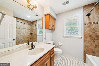 Welcome to this beautiful brick front home nestled on a sweeping on Hidden Hills Country Club in Georgia - for sale on GolfHomes.com, golf home, golf lot