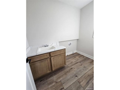 Ready to move in - includes the irrigation system, sod, and on St Clair River Country Club in Michigan - for sale on GolfHomes.com, golf home, golf lot