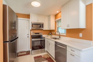 This move-in ready home is perfectly situated between vibrant on The Dunedin Country Club in Florida - for sale on GolfHomes.com, golf home, golf lot