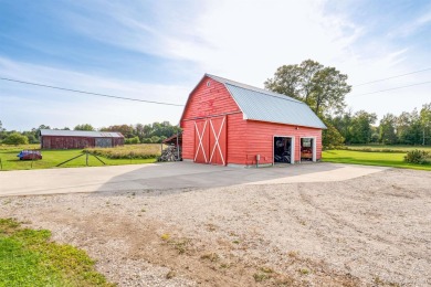 This picture perfect farmhouse sits nestled in the fields at the on Hiawatha Sportsmans Golf Club in Michigan - for sale on GolfHomes.com, golf home, golf lot