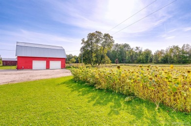 This picture perfect farmhouse sits nestled in the fields at the on Hiawatha Sportsmans Golf Club in Michigan - for sale on GolfHomes.com, golf home, golf lot