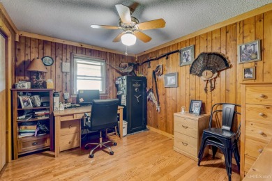 This picture perfect farmhouse sits nestled in the fields at the on Hiawatha Sportsmans Golf Club in Michigan - for sale on GolfHomes.com, golf home, golf lot