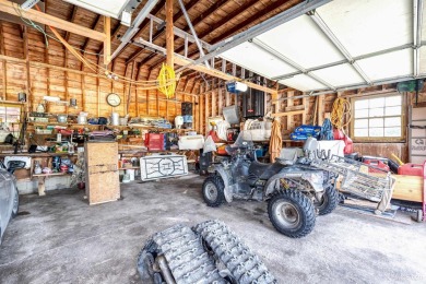 This picture perfect farmhouse sits nestled in the fields at the on Hiawatha Sportsmans Golf Club in Michigan - for sale on GolfHomes.com, golf home, golf lot