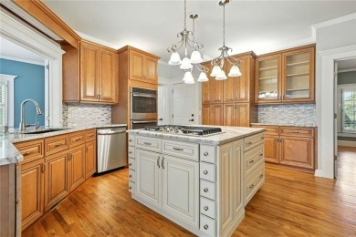 Overlooking manicured fairways and a sparkling lake, this home on The Golf Club At Bradshaw Farm in Georgia - for sale on GolfHomes.com, golf home, golf lot