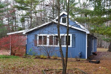 Discover the perfect retreat in this cozy chalet, ideally on Burning Oak Country Club in Michigan - for sale on GolfHomes.com, golf home, golf lot