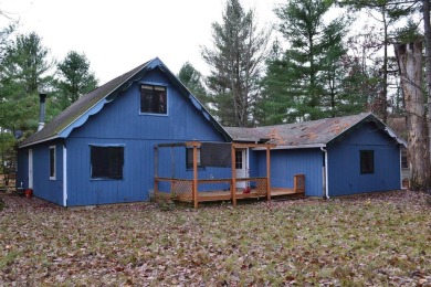 Discover the perfect retreat in this cozy chalet, ideally on Burning Oak Country Club in Michigan - for sale on GolfHomes.com, golf home, golf lot