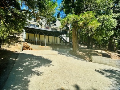 Nestled beneath towering pine trees, this charming 3-bedroom on Lake Arrowhead Country Club in California - for sale on GolfHomes.com, golf home, golf lot