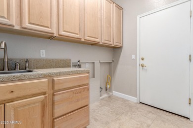 Gated community living at its best! This 4-bedroom, 2-bath home on Palm Valley Golf Club  in Arizona - for sale on GolfHomes.com, golf home, golf lot