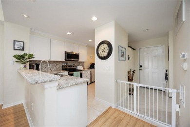 Enjoy waterfront living in this turnkey bright end-unit villa on Sabal Trace Golf and Country Club in Florida - for sale on GolfHomes.com, golf home, golf lot