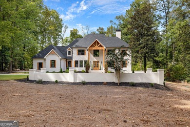 Welcome to this breathtaking four-sided brick estate, perfectly on Whitewater Creek in Georgia - for sale on GolfHomes.com, golf home, golf lot