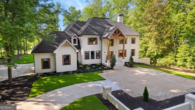 Welcome to this breathtaking four-sided brick estate, perfectly on Whitewater Creek in Georgia - for sale on GolfHomes.com, golf home, golf lot