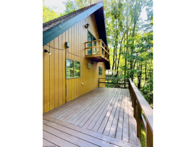 This open concept chalet home is nestled in the woods of Alpine on Alpine Lake Resort in West Virginia - for sale on GolfHomes.com, golf home, golf lot