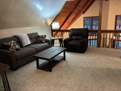 This open concept chalet home is nestled in the woods of Alpine on Alpine Lake Resort in West Virginia - for sale on GolfHomes.com, golf home, golf lot