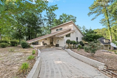 The bedroom upstairs has a private bath, whirlpool tub, shower on Lake Forest Yacht and Country Club in Alabama - for sale on GolfHomes.com, golf home, golf lot