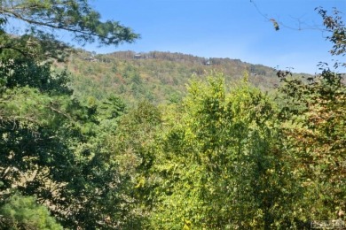 Nestled on a sprawling private lot, this enchanting on Sapphire National Golf Club in North Carolina - for sale on GolfHomes.com, golf home, golf lot