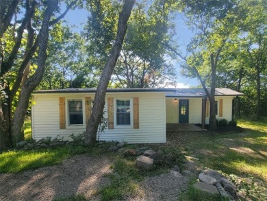 Tucked away on a double lot in the gated community of Linn on Linn Valley Lakes - Deer Trace Golf Course in Kansas - for sale on GolfHomes.com, golf home, golf lot