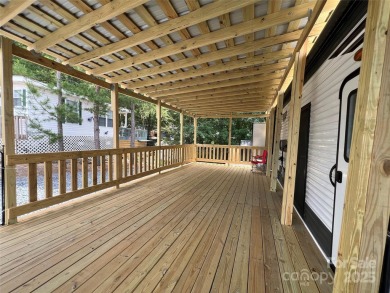 Start Lake Life Today! This 2021 spacious camper 12'x30' covered on Old North State Club at Uwharrie Point Golf community in North Carolina - for sale on GolfHomes.com, golf home, golf lot