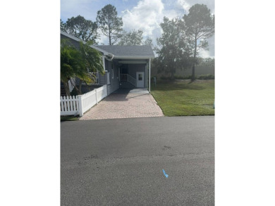 This has says WOW as you pull up to the gorgeously landscaped on Golden Lakes Golf Course in Florida - for sale on GolfHomes.com, golf home, golf lot