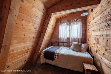 Nestled among a serene canopy of mature trees, this charming on Star Valley RV Golf Course in Wyoming - for sale on GolfHomes.com, golf home, golf lot