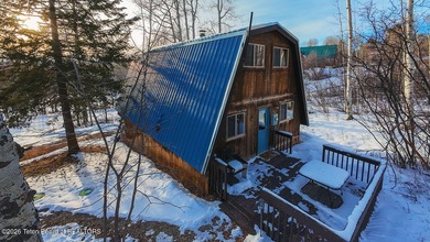 Nestled among a serene canopy of mature trees, this charming on Star Valley RV Golf Course in Wyoming - for sale on GolfHomes.com, golf home, golf lot