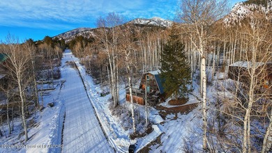 Nestled among a serene canopy of mature trees, this charming on Star Valley RV Golf Course in Wyoming - for sale on GolfHomes.com, golf home, golf lot