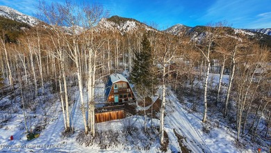 Nestled among a serene canopy of mature trees, this charming on Star Valley RV Golf Course in Wyoming - for sale on GolfHomes.com, golf home, golf lot