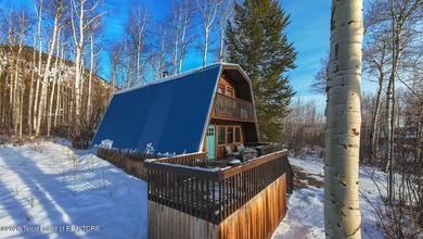 Nestled among a serene canopy of mature trees, this charming on Star Valley RV Golf Course in Wyoming - for sale on GolfHomes.com, golf home, golf lot