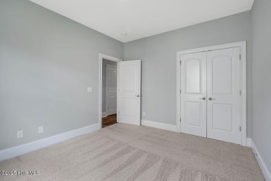 This beautiful and well-maintained coastal home is within on Cape Fear National At Brunswick Forest in North Carolina - for sale on GolfHomes.com, golf home, golf lot