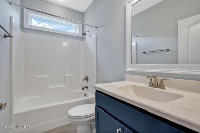This beautiful and well-maintained coastal home is within on Cape Fear National At Brunswick Forest in North Carolina - for sale on GolfHomes.com, golf home, golf lot