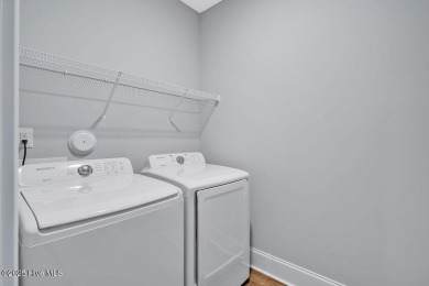 This beautiful and well-maintained coastal home is within on Cape Fear National At Brunswick Forest in North Carolina - for sale on GolfHomes.com, golf home, golf lot