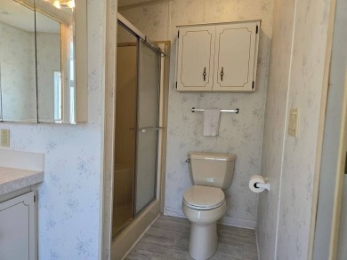 This lovely 2-bedroom partially furnished home on a corner lot on Pine Lakes Country Club in Florida - for sale on GolfHomes.com, golf home, golf lot