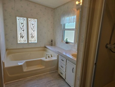 This lovely 2-bedroom partially furnished home on a corner lot on Pine Lakes Country Club in Florida - for sale on GolfHomes.com, golf home, golf lot