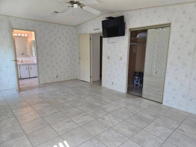 This lovely 2-bedroom partially furnished home on a corner lot on Pine Lakes Country Club in Florida - for sale on GolfHomes.com, golf home, golf lot