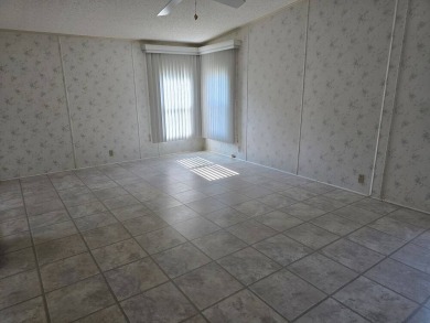 This lovely 2-bedroom partially furnished home on a corner lot on Pine Lakes Country Club in Florida - for sale on GolfHomes.com, golf home, golf lot