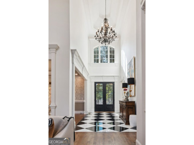 Privately tucked behind a long, tree-lined driveway and greeted on Chateau Elan Golf Club  in Georgia - for sale on GolfHomes.com, golf home, golf lot
