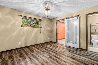 Welcome home to a warm and inviting retreat tucked away among on Holly Lake Ranch Golf Club in Texas - for sale on GolfHomes.com, golf home, golf lot