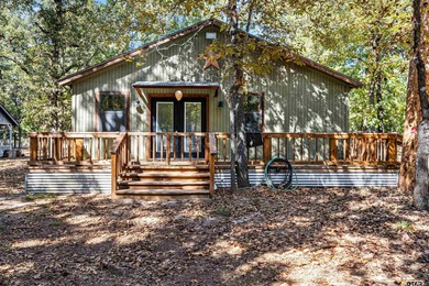 Welcome home to a warm and inviting retreat tucked away among on Holly Lake Ranch Golf Club in Texas - for sale on GolfHomes.com, golf home, golf lot