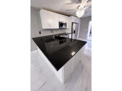 Welcome home! Fully renovated luxury patio home stands far above on Poinciana Golf Club in Florida - for sale on GolfHomes.com, golf home, golf lot