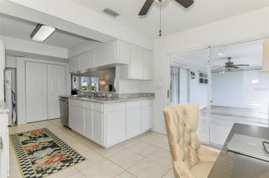 Charming 3-bedroom, 2-bathroom, canal-front home in the highly on Pinemoor West Golf Club in Florida - for sale on GolfHomes.com, golf home, golf lot