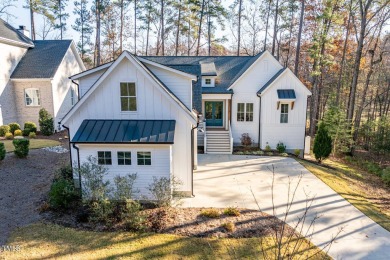 This modern farmhouse is a dream for anyone who loves both style on The Preserve At Jordan Lake Golf Club in North Carolina - for sale on GolfHomes.com, golf home, golf lot