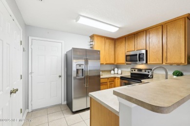 Enjoy low-maintenance living in this two-story townhome located on Golf Club At Fleming Island in Florida - for sale on GolfHomes.com, golf home, golf lot