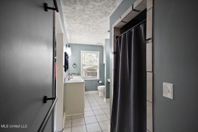 This charming 3-bedroom, 2-bath home, nestled in the heart of on Pearl Municipal Golf Course in Mississippi - for sale on GolfHomes.com, golf home, golf lot