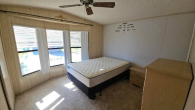 Cute 2 bedroom 2 bath home with newer flooring and is partially on Golden Lakes Golf Course in Florida - for sale on GolfHomes.com, golf home, golf lot