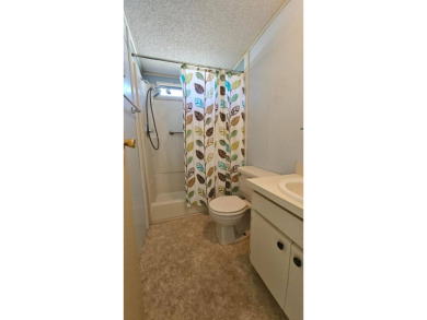 Cute 2 bedroom 2 bath home with newer flooring and is partially on Golden Lakes Golf Course in Florida - for sale on GolfHomes.com, golf home, golf lot