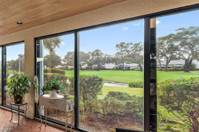 Enjoy golf and water views from this charming one-story on Delray Dunes Golf and Country Club in Florida - for sale on GolfHomes.com, golf home, golf lot