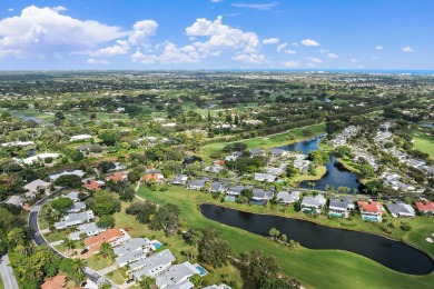 Enjoy golf and water views from this charming one-story on Delray Dunes Golf and Country Club in Florida - for sale on GolfHomes.com, golf home, golf lot